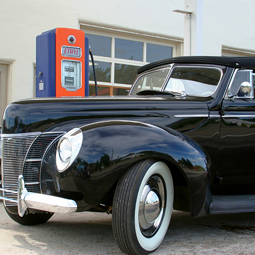 A black hot rod with whitewall tires