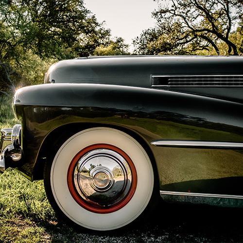 A whitewall tire mounted on a classic car