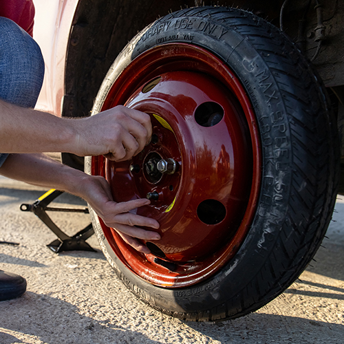 Spare tire being mounted